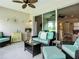 Inviting sunroom with sliding glass doors, comfortable seating, and pleasant decor at 15860 Aurora Lake Cir, Wimauma, FL 33598