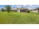 Expansive backyard featuring a well-maintained lawn and a partially screened patio area at 17668 Bright Wheat Dr, Lithia, FL 33547