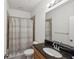 Well-lit bathroom featuring a granite vanity and a shower with neutral colored tile at 17668 Bright Wheat Dr, Lithia, FL 33547