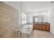 Spa-like bathroom featuring a glass-enclosed shower, soaking tub, and a double vanity, creating a relaxing retreat at 17668 Bright Wheat Dr, Lithia, FL 33547