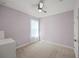 Cozy bedroom with soft lavender walls, light carpet, ceiling fan and natural light at 17668 Bright Wheat Dr, Lithia, FL 33547