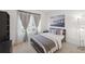 Cozy bedroom features a decorative window with sheer curtains and a pier-themed art piece at 17668 Bright Wheat Dr, Lithia, FL 33547