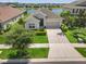 Beautiful single-Gathering home featuring manicured landscaping, a two-car garage, and serene water views at 17668 Bright Wheat Dr, Lithia, FL 33547