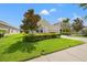 Well-kept house boasts a vibrant green lawn, trimmed shrubs, and a tidy landscape design at 17668 Bright Wheat Dr, Lithia, FL 33547