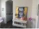 View of the hallway into the kitchen with a contemporary painting and matching desk at 17668 Bright Wheat Dr, Lithia, FL 33547