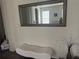 Hallway with a padded bench, mirror and artistic vase, for a modern accent at 17668 Bright Wheat Dr, Lithia, FL 33547