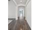 Bright hallway with arched entryways showcases modern flooring and a glimpse of the lake view beyond at 17668 Bright Wheat Dr, Lithia, FL 33547