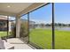 Relaxing screened-in lanai with views of the pristine lawn and serene lake at 17668 Bright Wheat Dr, Lithia, FL 33547