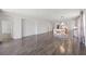Open concept living room and kitchen space, featuring wood flooring, dining table and modern lighting fixtures at 17668 Bright Wheat Dr, Lithia, FL 33547