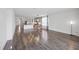 Spacious living area flows into a modern kitchen and dining area with beautiful wood-look floors at 17668 Bright Wheat Dr, Lithia, FL 33547