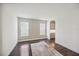 Clean room with a white brick accent wall, hardwood floors, and arched doorway at 17668 Bright Wheat Dr, Lithia, FL 33547