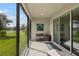 Relaxing screened-in patio offers peaceful views of the well-manicured lawn and neighborhood pond at 17668 Bright Wheat Dr, Lithia, FL 33547