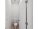 Simple powder room featuring a standard white toilet and neutral tile flooring, illuminated by overhead lighting at 17668 Bright Wheat Dr, Lithia, FL 33547