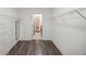 Spacious walk-in closet with wood-look floors and wire shelving, leading to an adjacent room at 17668 Bright Wheat Dr, Lithia, FL 33547