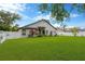 Large backyard with green grass, mature landscaping, and a view of the home's exterior at 1806 Powder Ridge Dr, Valrico, FL 33594