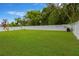 Expansive backyard featuring lush green grass and a pristine white fence, perfect for outdoor activities and privacy at 1806 Powder Ridge Dr, Valrico, FL 33594
