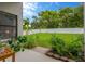 Landscaped backyard featuring a white fence and a variety of plants and trees at 1806 Powder Ridge Dr, Valrico, FL 33594