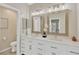 Bathroom featuring double sinks, white cabinets, and framed mirrors at 1806 Powder Ridge Dr, Valrico, FL 33594