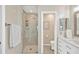Bathroom featuring a walk-in shower with marble tile, sleek vanity, and toilet in a separate nook at 1806 Powder Ridge Dr, Valrico, FL 33594