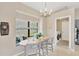 Cozy dining area with a window seat, chandelier, and access to laundry room at 1806 Powder Ridge Dr, Valrico, FL 33594