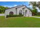 Charming single-story home with arched windows, a well-manicured lawn, and a two-car garage at 1806 Powder Ridge Dr, Valrico, FL 33594