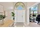 Bright foyer with white door, decorative rug and large window above at 1806 Powder Ridge Dr, Valrico, FL 33594