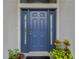 Close up of the blue front door with sidelights and a black welcome mat at 1806 Powder Ridge Dr, Valrico, FL 33594