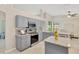 Modern kitchen with gray cabinets, granite countertops, and stainless steel appliances at 1806 Powder Ridge Dr, Valrico, FL 33594