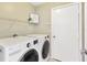 Functional laundry room with modern appliances, shelving, and a storage closet at 1806 Powder Ridge Dr, Valrico, FL 33594