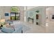 Spacious living room with large windows, tile floors, and light blue sofas at 1806 Powder Ridge Dr, Valrico, FL 33594