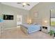 Main bedroom boasts vaulted ceiling, a ceiling fan, and view to the attached bath at 1806 Powder Ridge Dr, Valrico, FL 33594