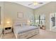 Bright main bedroom featuring vaulted ceiling, a ceiling fan, and large windows at 1806 Powder Ridge Dr, Valrico, FL 33594