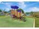 Colorful playground with slides, ladders, and climbing structures set on a green safety surface at 1806 Powder Ridge Dr, Valrico, FL 33594