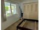 Bedroom featuring empty bed frame, closet and view out window at 2060 Marilyn St # 121, Clearwater, FL 33765