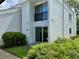 Condo exterior with sliding glass doors leading to a small patio and garden area at 2060 Marilyn St # 121, Clearwater, FL 33765