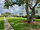 Exterior shot of buildings with a well-maintained lawn and mature trees at 2060 Marilyn St # 121, Clearwater, FL 33765