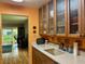 Eat-in kitchen featuring wood cabinets, light countertops, and view into adjacent living area at 2060 Marilyn St # 121, Clearwater, FL 33765