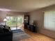Living room with light hardwood floors, neutral walls, and sliding glass doors to the outside at 2060 Marilyn St # 121, Clearwater, FL 33765