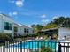 Community pool area with sun loungers, surrounded by well-manicured landscaping at 2060 Marilyn St # 121, Clearwater, FL 33765
