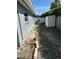 Side yard showing building's edge, storage shed and partial fencing at 2198 Academy Dr, Clearwater, FL 33764