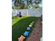 Backyard featuring artificial grass and playful, colorful turtle stepping stones at 2198 Academy Dr, Clearwater, FL 33764