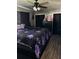 Comfortable bedroom featuring dark accents, a ceiling fan, and ample natural light at 2198 Academy Dr, Clearwater, FL 33764