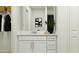 Bathroom featuring a vanity with a sink, a black vase with greenery, and modern art at 2223 Blue Grosbeak Pl, Wimauma, FL 33598