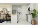 Modern kitchen featuring white cabinets, stainless steel appliances, and a breakfast bar with seating at 2223 Blue Grosbeak Pl, Wimauma, FL 33598