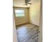 Bright bedroom featuring wood-look floors and a ceiling fan at 2271 Terrace N Dr, Clearwater, FL 33765