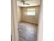 Neutral bedroom with wood-look floors and natural light from the window at 2271 Terrace N Dr, Clearwater, FL 33765