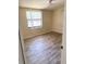 Inviting bedroom with wood-look floors, ceiling fan, and ample natural light at 2271 Terrace N Dr, Clearwater, FL 33765