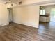 Open-concept living room featuring wood-look floors and seamless flow to kitchen at 2271 Terrace N Dr, Clearwater, FL 33765