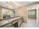Bathroom featuring a large mirror, granite countertop, and tiled flooring at 2309 Cypress Walk Way, Ruskin, FL 33570