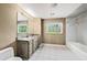 Bright bathroom featuring tile floors, a window view, and updated vanity at 2309 Cypress Walk Way, Ruskin, FL 33570